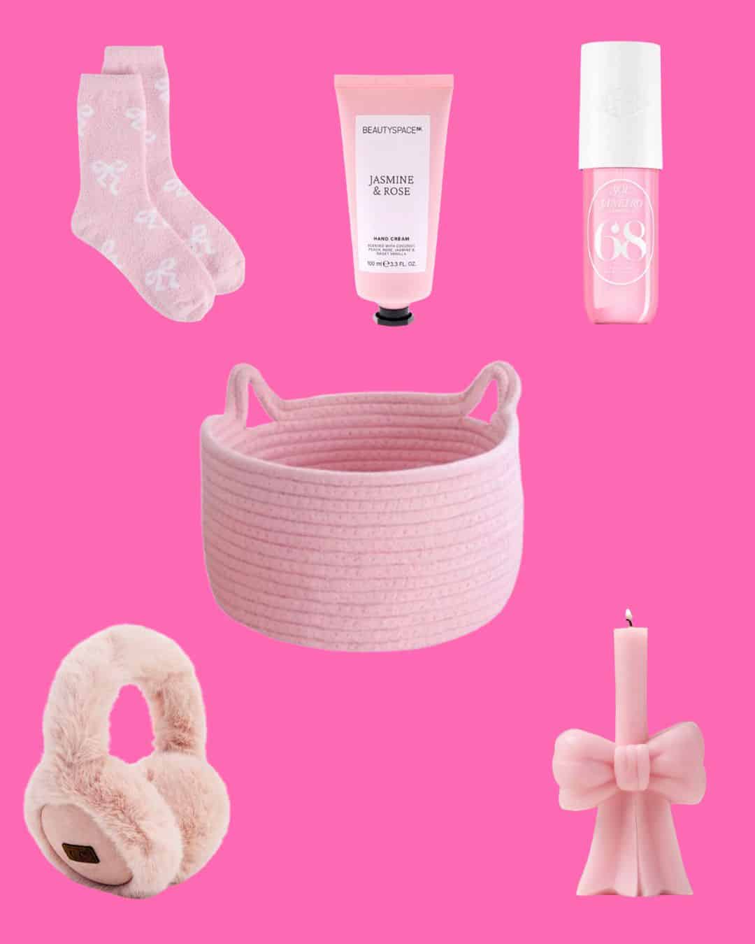 A flat lay of pink items on a pink background: socks, hand cream, nail polish, a rope basket with cat ears, earmuffs, and a candle shaped like a bow.