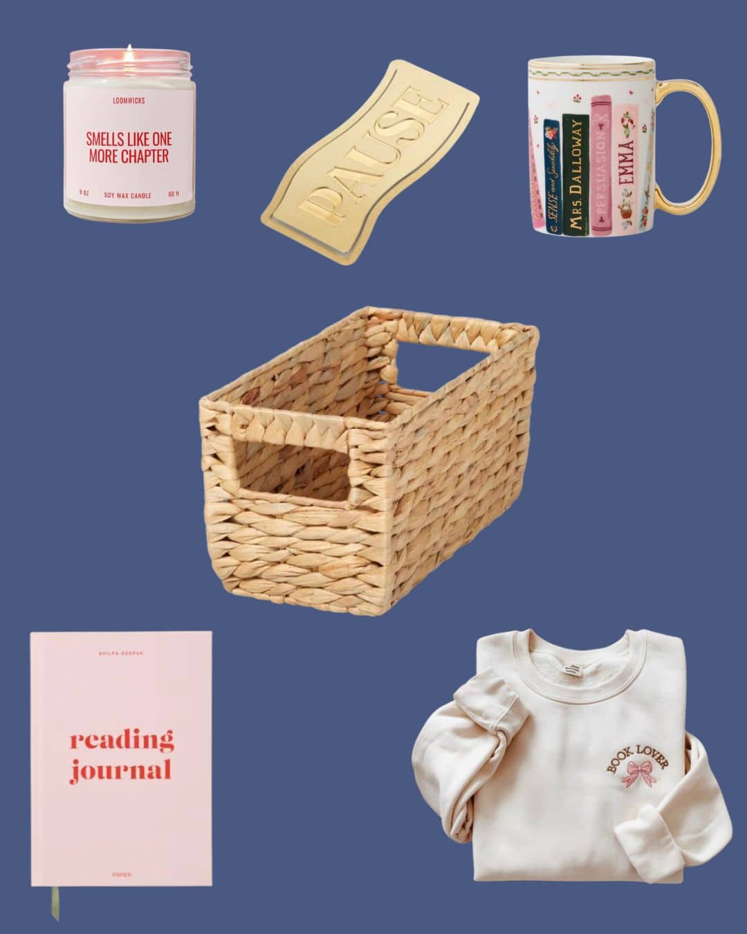A flat lay featuring a pink candle, a gold bookmark labeled PAUSE, a white mug with book-themed designs, a woven basket, a pink reading journal, and a cream sweatshirt with BOOK LOVER text.
