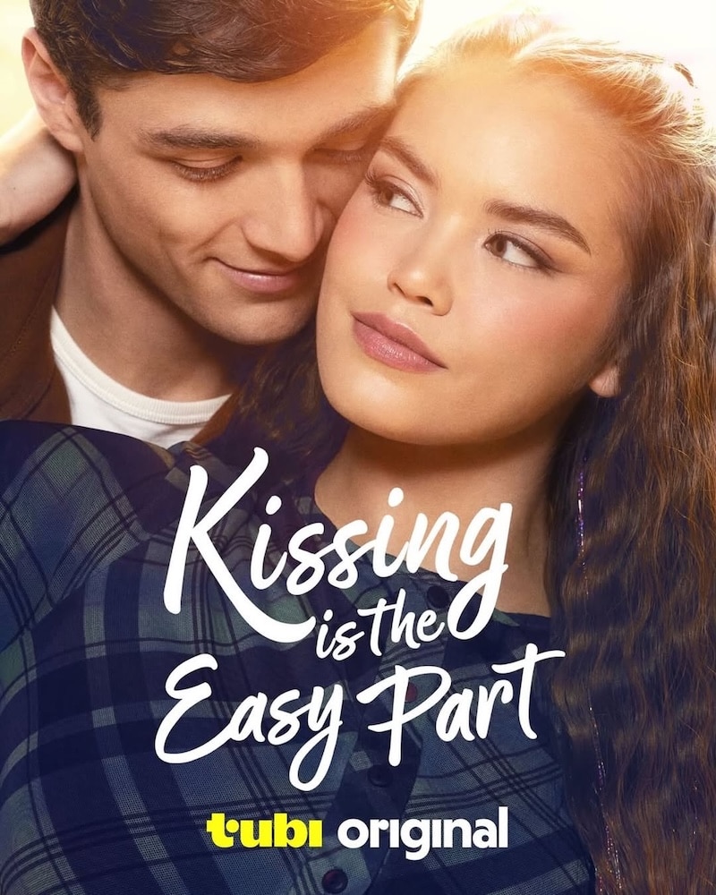 A young couple embraces closely, smiling softly at each other like characters from Wattpad novels. The text over the image reads Kissing is the Easy Part. The bottom has the yellow and white tubi original logo.