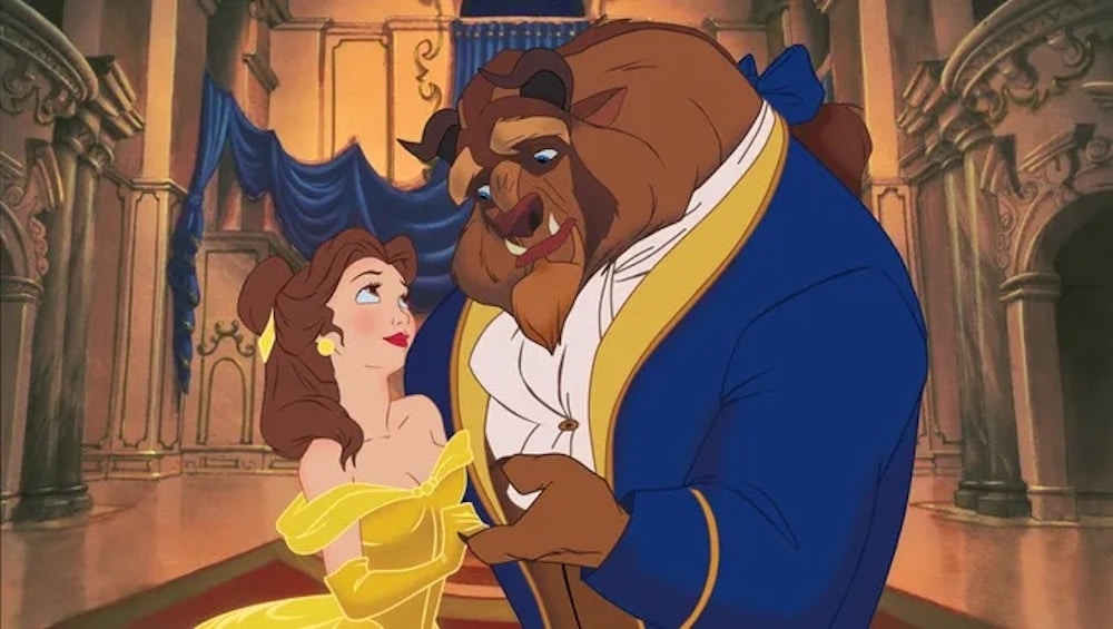 An animated woman in a yellow gown dances with a large beast in a royal blue suit inside a grand, ornate ballroom—bringing to life one of our favorite childhood flicks and sharing timeless love advice with every graceful twirl.
