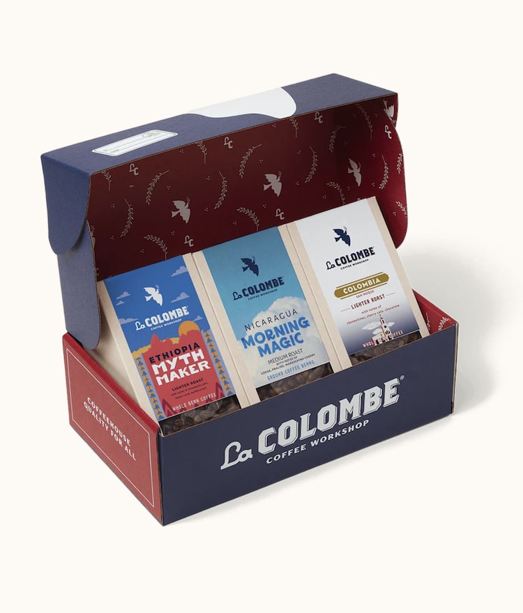An open La Colombe Coffee Workshop gift box displays three bags of coffee: Ethiopia Myth Maker, Nicaragua Morning Magic, and Colombia Los Rosales, standing upright inside the branded box.