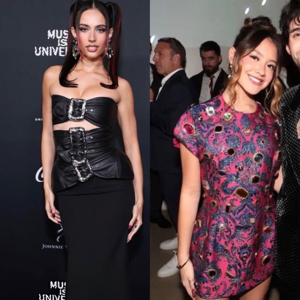 Two women pose side by side: the left wears a strapless black dress with silver buckles and the right wears a pink and purple patterned mini dress, smiling in a crowded indoor setting—capturing one of their favorite Grammy moments.