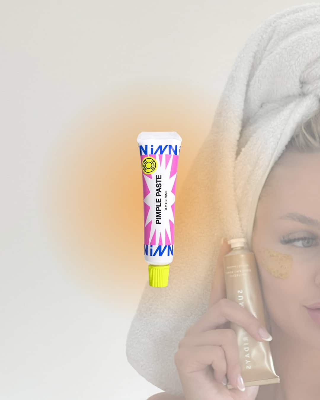 A woman with a towel wrapped around her head applies a skincare product under her eye as part of her skincare routine. In front of her, a tube labeled “PIMPLE PASTE” with a yellow cap and colorful design is displayed.