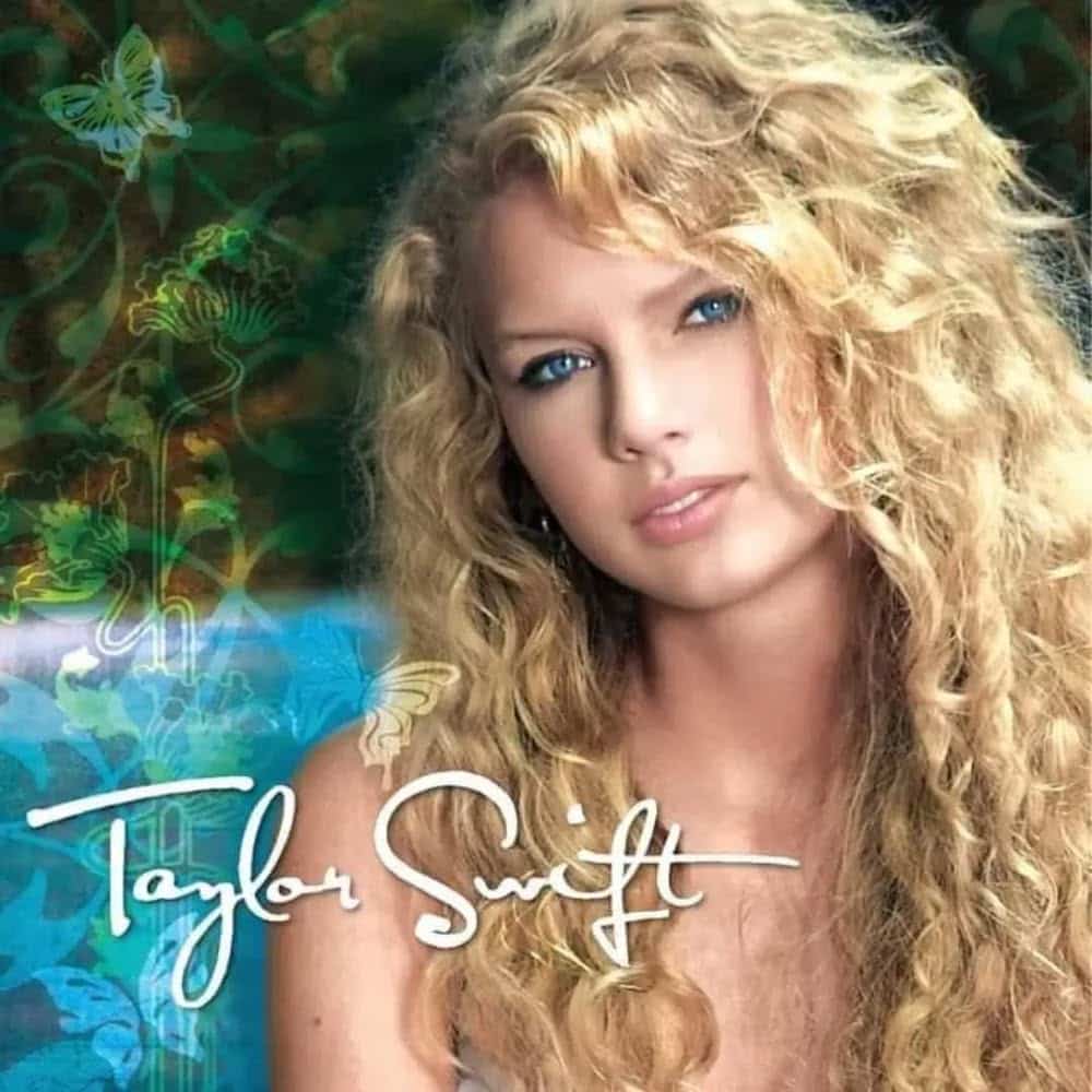 A young woman with long, curly blonde hair and blue eyes looks at the camera. She wears a light top, set against a green background with butterfly motifs—evoking the dreamy vibes of a Taylor Swift album. "Taylor Swift" is written in white script across the image.