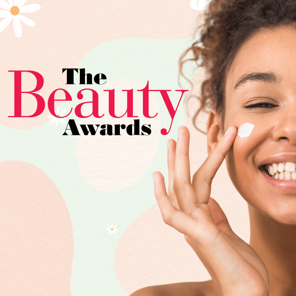 Smiling woman applying face cream on her cheek, with WIN and The Beauty Award winners text on a pastel, abstract background with white flowers.