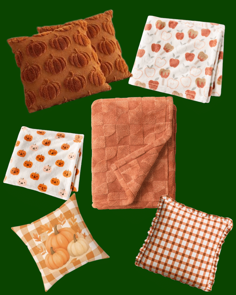 A collage of fall-themed home decor items, including two pumpkin-patterned pillows, two apple-patterned blankets, one solid orange blanket, a pumpkin-patterned blanket, and two plaid pumpkin pillows on a green background.