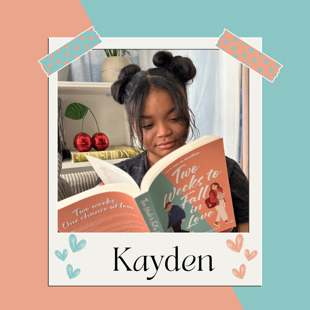 A young girl with two space buns reads a book titled Two Weeks to Fall in Love, dreaming about boyfriends. She sits by a bookshelf with decorative items, framed with pastel tape graphics and the name Kayden at the bottom.