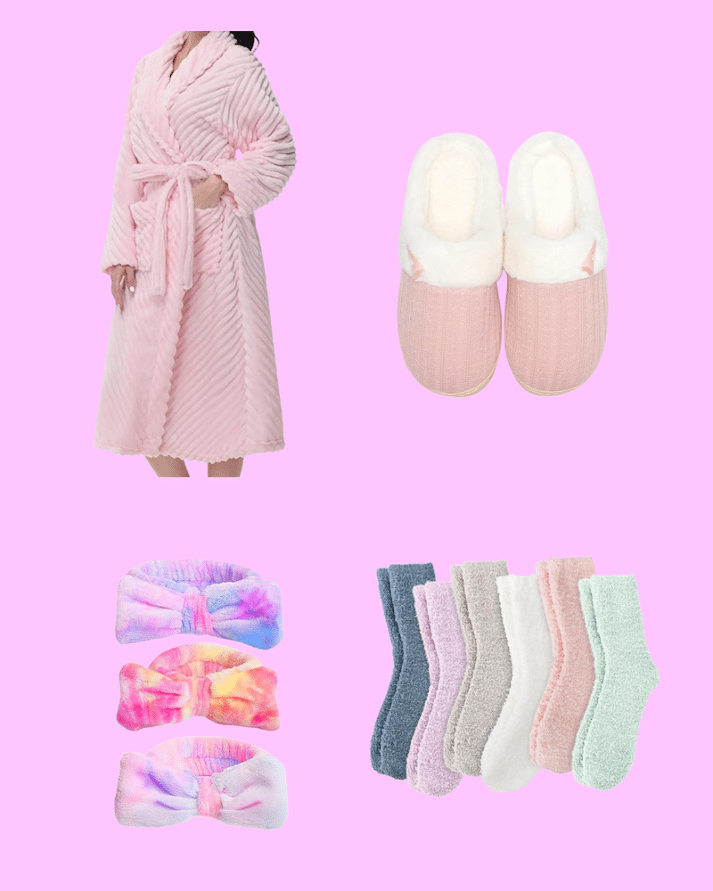 A cozy pink robe, a pair of pink and white slippers, three colorful headbands, and six pairs of fuzzy socks in pastel shades set the scene for the best spa day or relaxing at-home spa day on a dreamy pink background.