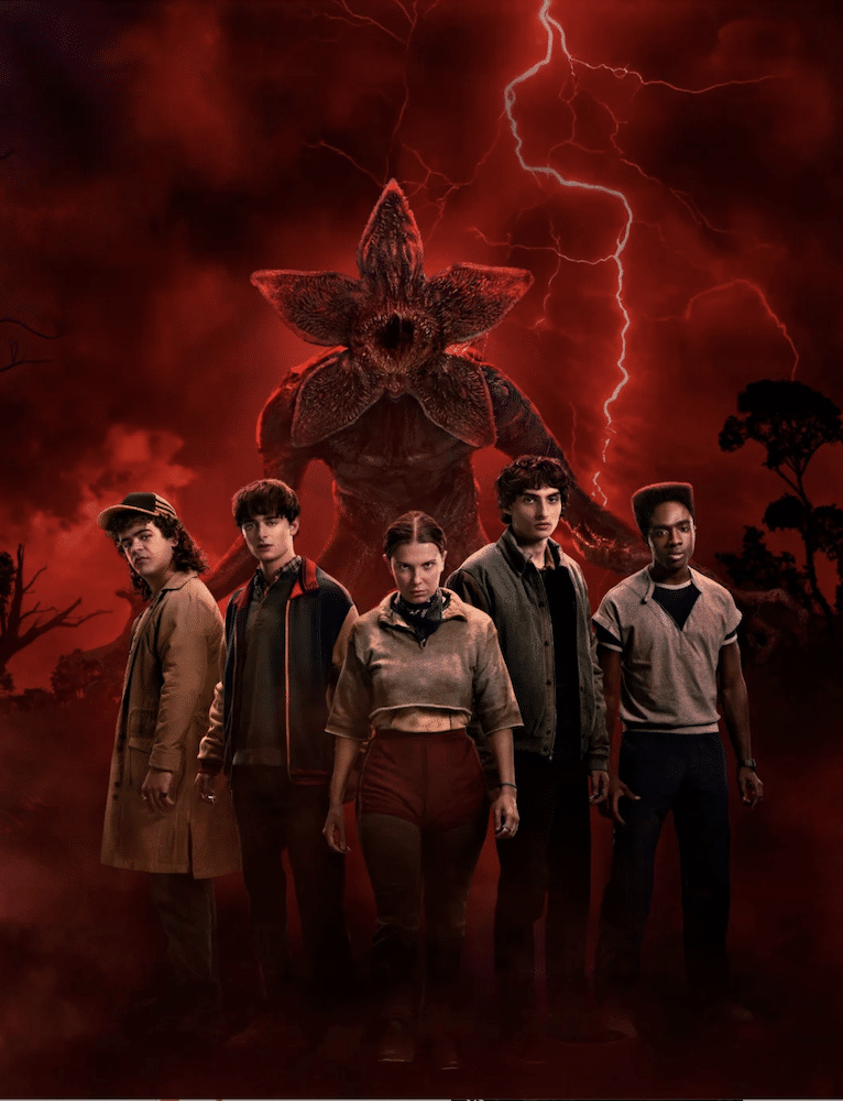 Five teens stand together, facing forward, with a monstrous Stranger Things Character with a flower-like head behind them. Red lightning and a dark, smoky, red sky above add a dramatic, almost Zodiac-level eerie atmosphere.