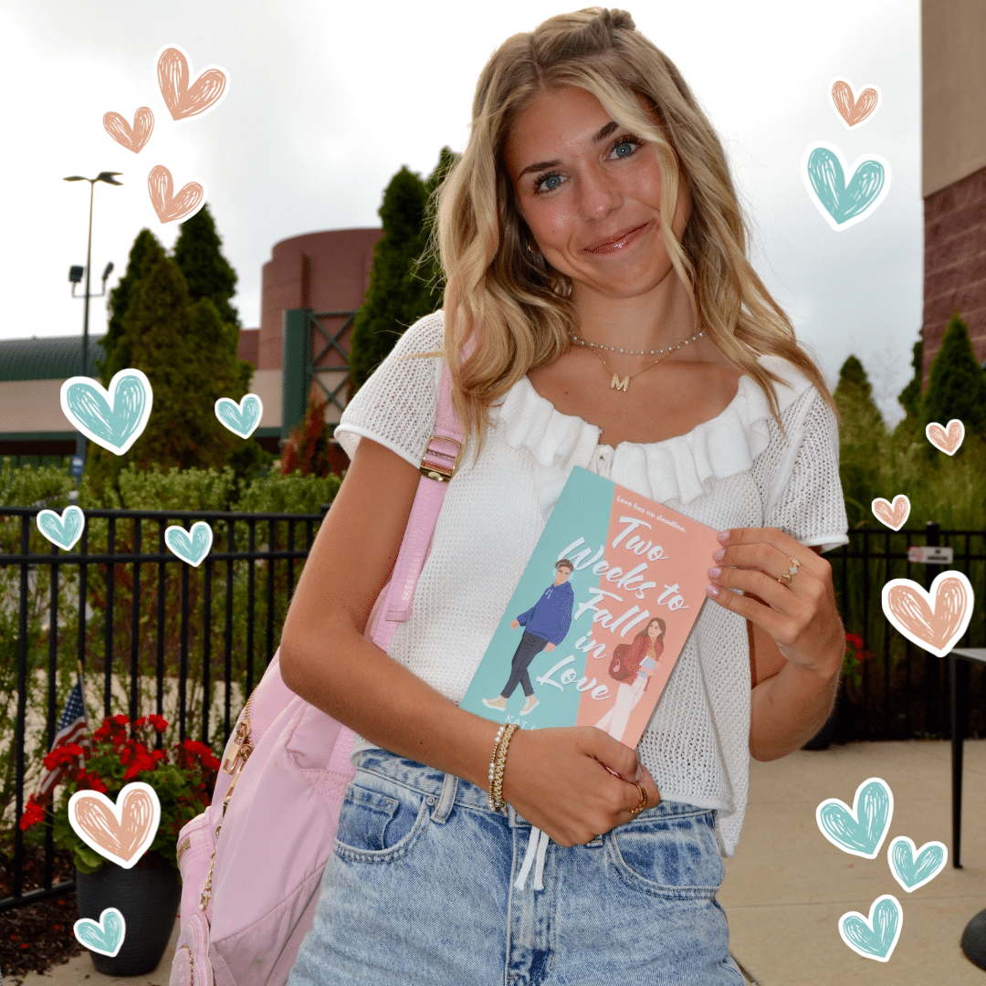 A smiling young woman with wavy blonde hair holds a book titled Two Weeks to Fall in Love. Dressed in a white sweater and denim shorts with a pink backpack, she stands outdoors, heart doodles hinting at new boyfriends after breakups.