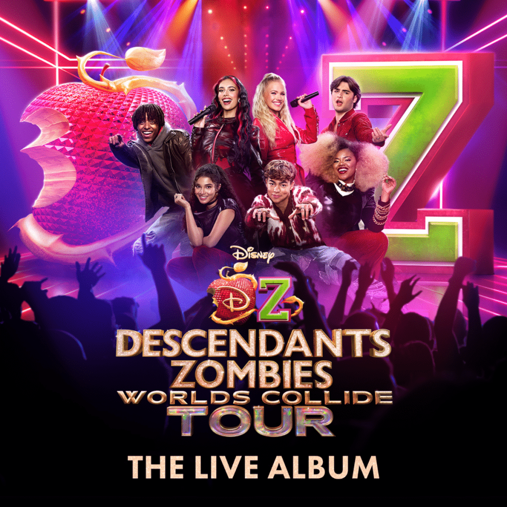 Six young performers pose enthusiastically on stage with large red apple and green “Z” props behind them. The text reads “Descendants Zombies Worlds Collide Tour: The Live Album.” Bright lights shine overhead at this worlds collide concert special.